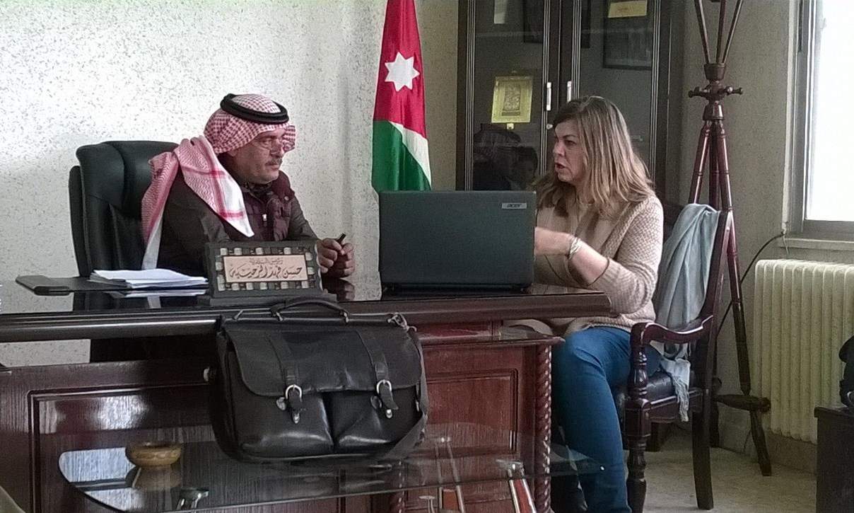 Umm al-Jimal Mayor Hassan al-Rahaibeh (left) listens as SCHEP Projects Lead Erin Addison (right) discusses ideas for developing small businesses and tourist facilities around the site. Photo by Glenn J. Corbett.