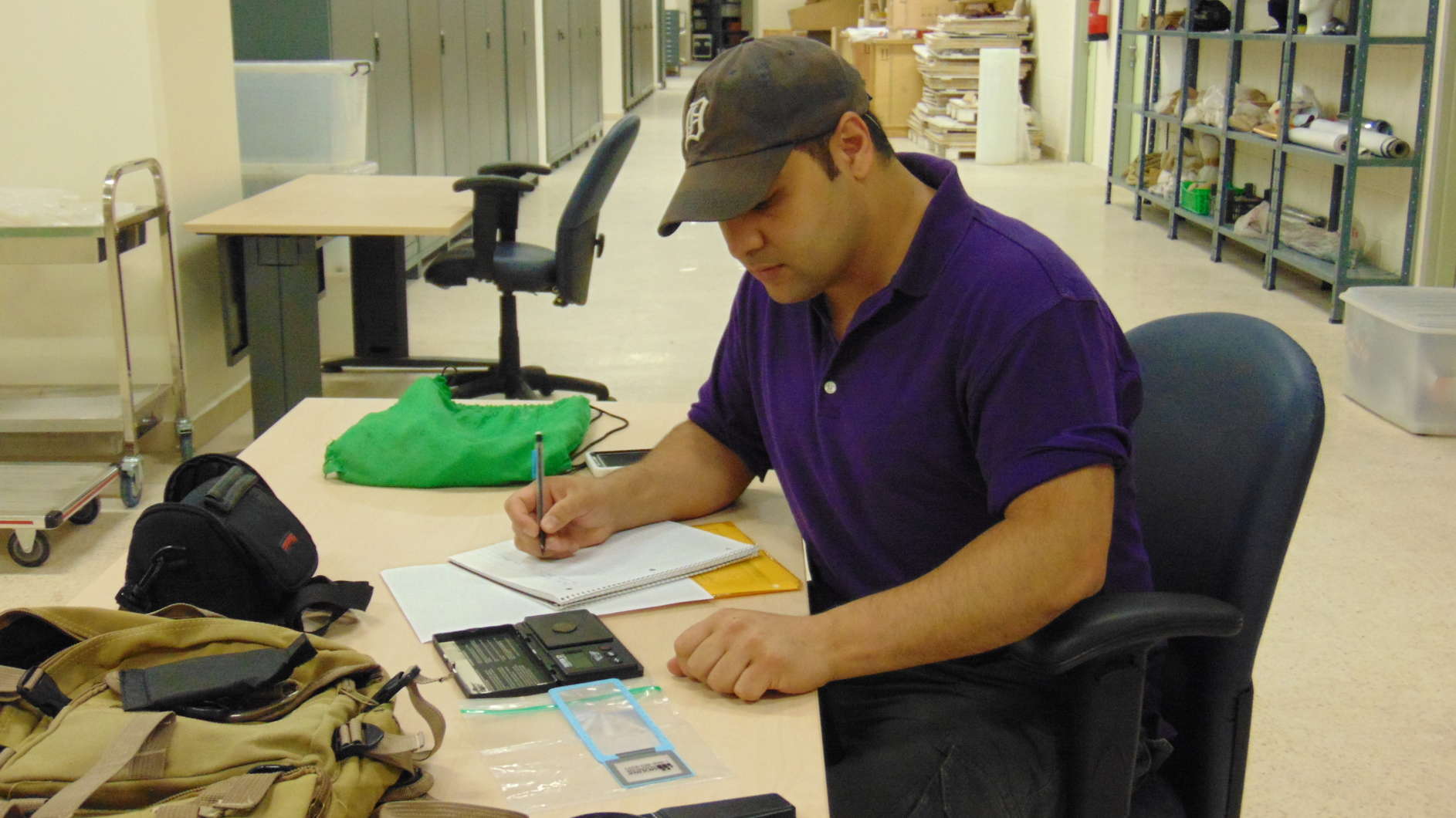 ACOR fellow Tareq Ramadan recording information about Umayyad coins, bullae, and other administrative objects held in the Jordan Museum. Photo courtesy Tareq Ramadan.