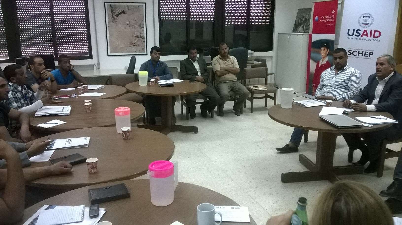 H.E. Hassan al-Rehaibeh (far right), mayor of Umm al-Jimal, with Umm al-Jimal site steward Muaffaq al-Masaeed to his left, leads a discussion about the role of host communities in preserving and promoting heritage sites. Photo by Glenn J. Corbett.