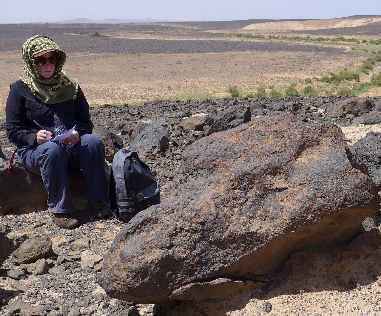 Kaelin M. Groom assessing a rock art panel at Wadi Hassan using the Rock Art Stability Index (RASI) method. Photo by C.D. Allen.