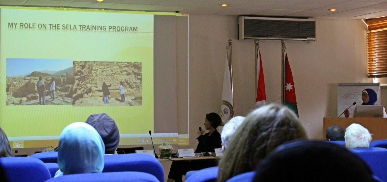 Eman Abdesalaam (far right at podium), SCHEP Site Steward at the Temple of the Winged Lions, presents on her experience with Sela and USAID SCHEP. Photo by Sofia Smith.